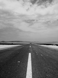 Road by sea against sky