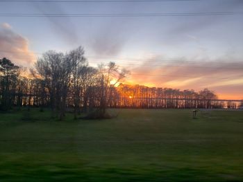 Scenic view of field against sky during sunset