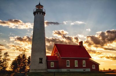 Low angle view of lighthouse against sky during sunset