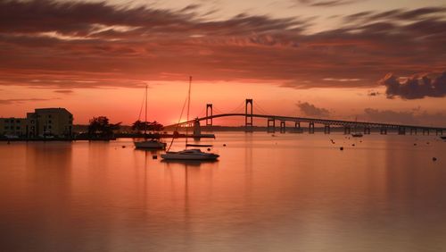 Sailboats in marina at sunset