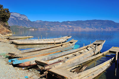 Panoramic view of boats moored in lake against blue sky