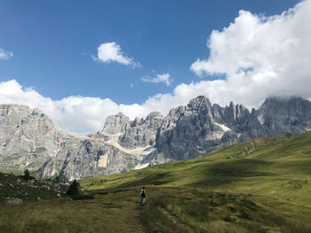 Scenic view of field and mountains against sky