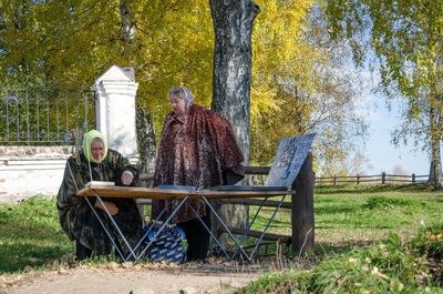 People sitting on bench in park