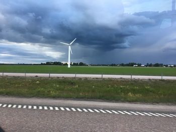 Windmill on field against sky