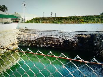Chainlink fence by water