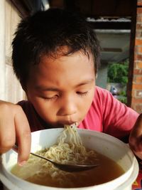 Portrait of boy eating food