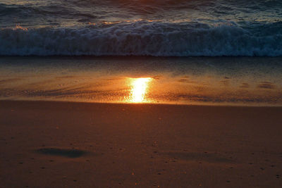 Scenic view of beach against sky during sunset