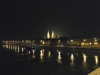 Reflection of illuminated buildings in water at night