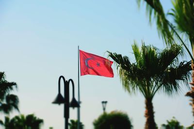 Low angle view of american flag against sky