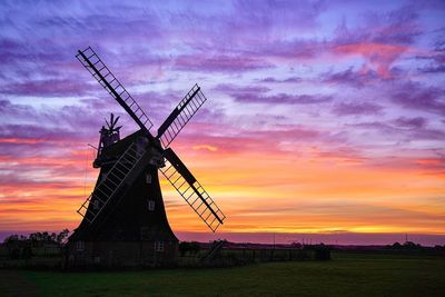 Low angle view of windmill against sky during sunset