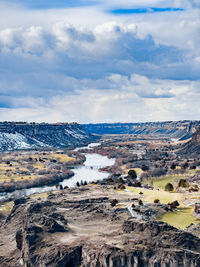 Aerial view of river canyon against sky