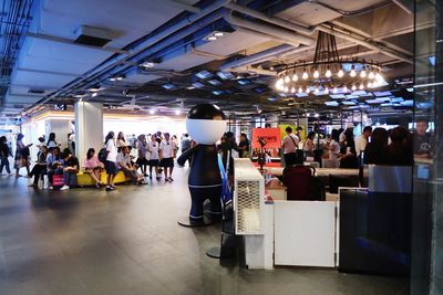 People standing in illuminated room