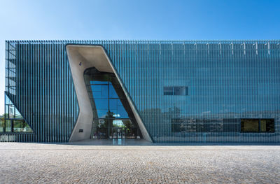 Low angle view of modern buildings against clear blue sky