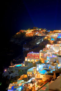 High angle view of illuminated buildings in city at night