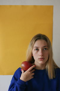 Close-up portrait of a young woman against white background