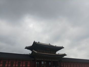 Low angle view of building against cloudy sky