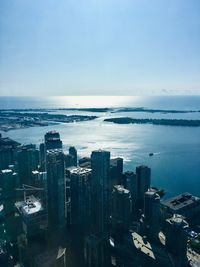 High angle view of buildings by sea against sky