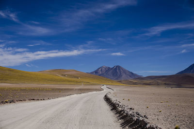 Country road leading towards mountains