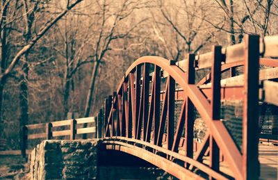 Bridge over river against bare trees