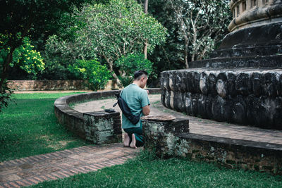 Full length of man standing on grass against trees