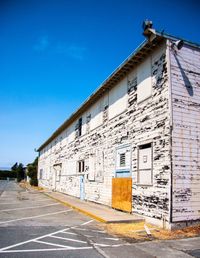 Abandoned building against clear blue sky