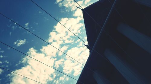 Low angle view of cables against sky