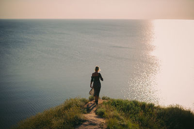 Rear view of man standing on beach