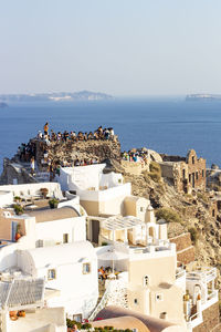 High angle view of buildings by sea against sky