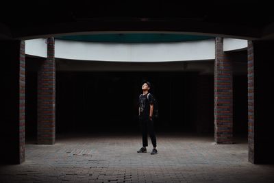 Full length portrait of man standing in corridor