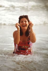 Portrait of a smiling young woman in sea