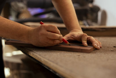 Cropped hands of man working at table