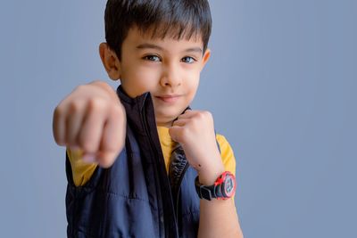 Portrait of young woman against white background