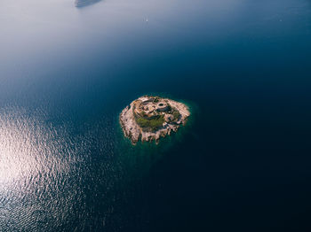 High angle view of rocks on sea shore