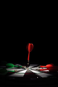 Close-up of illuminated lighting equipment against black background