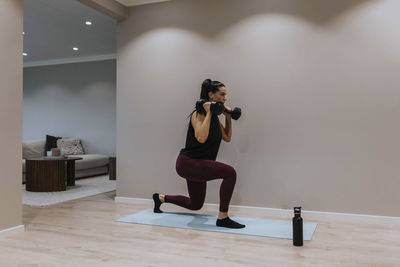 View of woman exercising at home