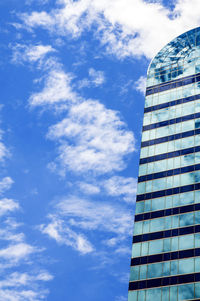 Low angle view of glass building against sky