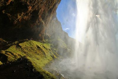 Scenic view of waterfall against sky