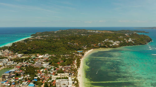 Shore of the tropical island of boracay with sandy beaches and hotels from above. 