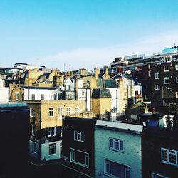 Buildings in city against blue sky