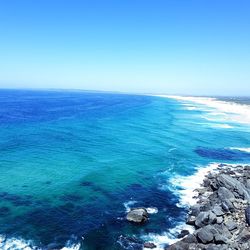 Scenic view of sea against clear blue sky