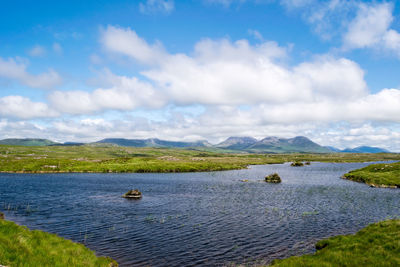 Scenic view of lake against cloudy sky