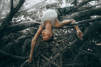 WOMAN LYING ON FIELD