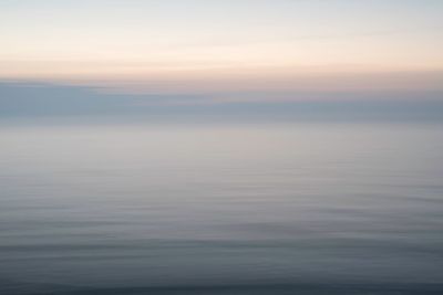 Scenic view of sea against sky at sunset