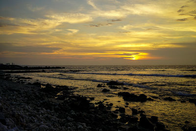 Scenic view of sea against orange sky