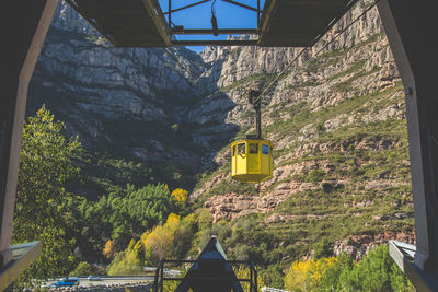 Overhead cable car against rocky mountain