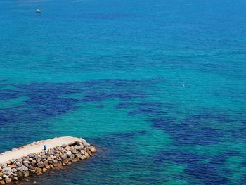 High angle view of rocks on sea