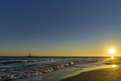 Scenic view of sea against clear sky during sunset