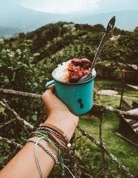 Close-up of hand holding ice cream cone