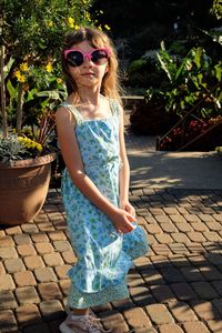 Portrait of woman with sunglasses against plants