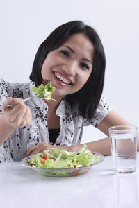 Portrait of a smiling young woman eating food